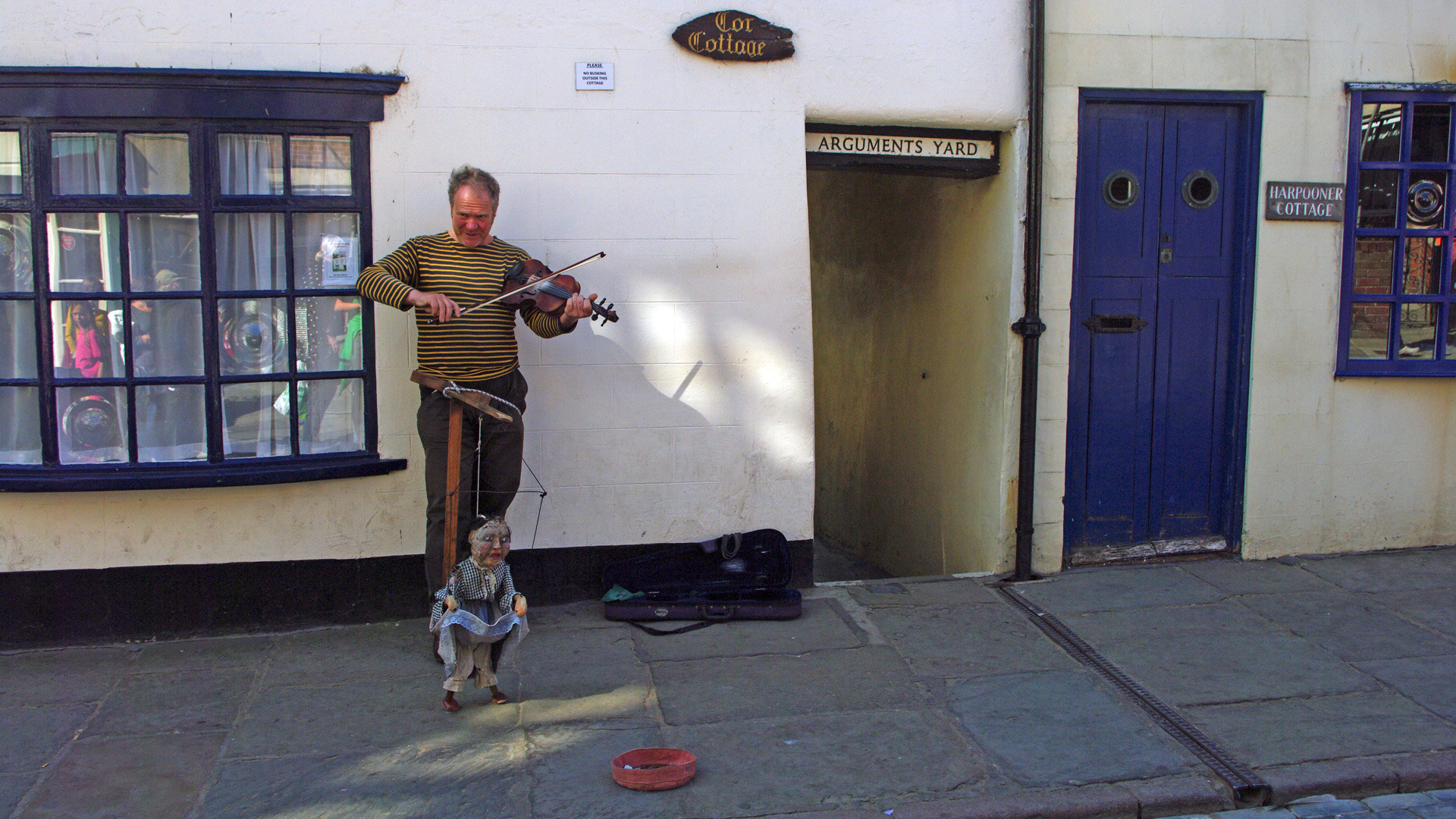 busker picturesque old town Whitby east side river Esk